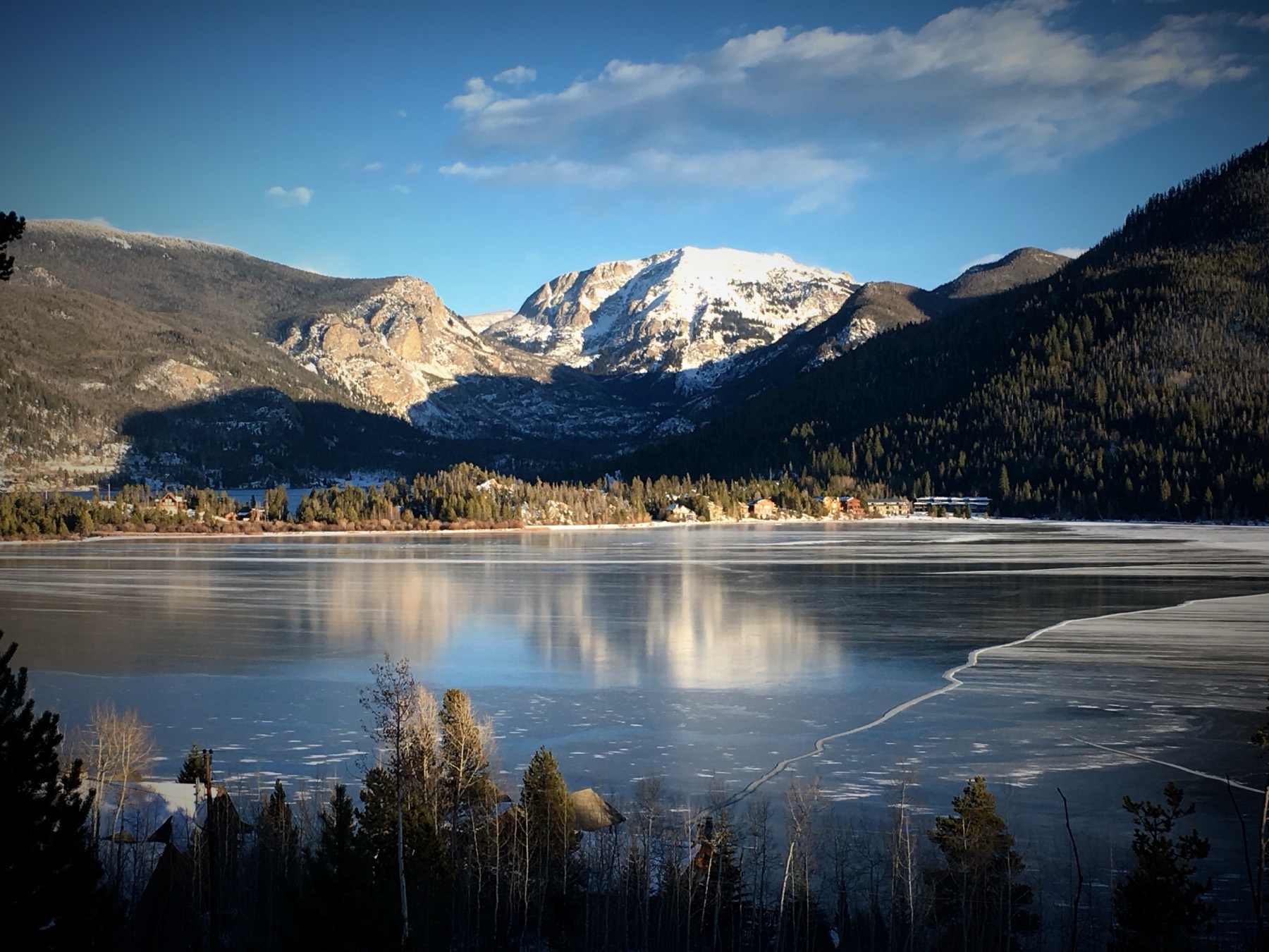 Frozen Grand Lake below the snow-dusted peaks of Rocky Mountain National Park